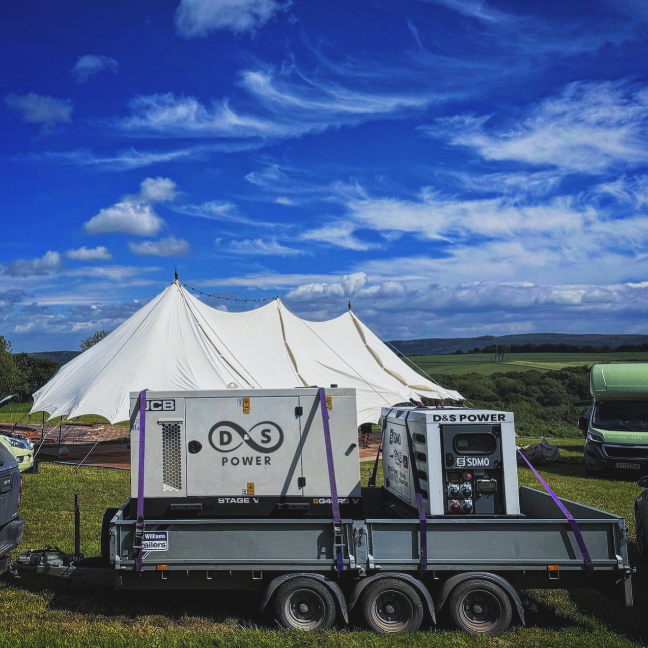 D&S Power generator supplying temporary power beside an outdoor marquee