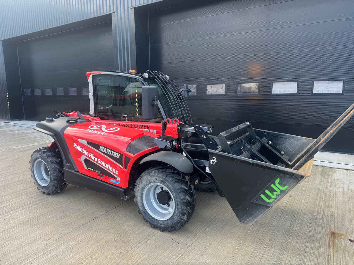 Red telehandler outside the workshop